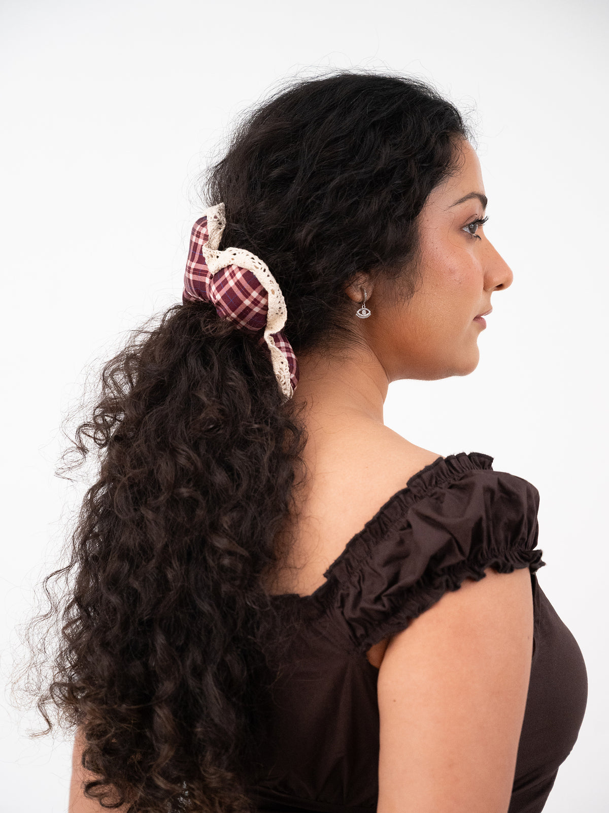 Side profile, curly hair half-up with the silk Wildpetal flower scrunchie