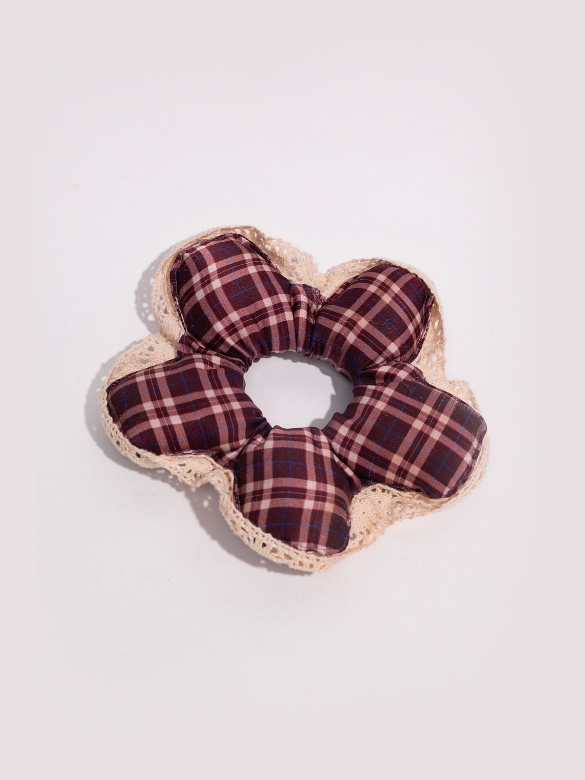 Up close: the soft sheen of maroon plaid mulberry silk beside a loop of cream cotton lace