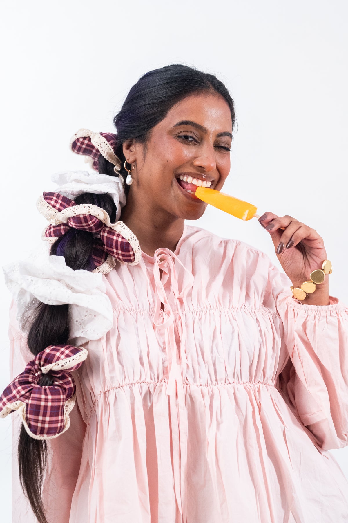 Eating an ice lolly, a long braid tied with Cloudy and the maroon plaid Wildpetal