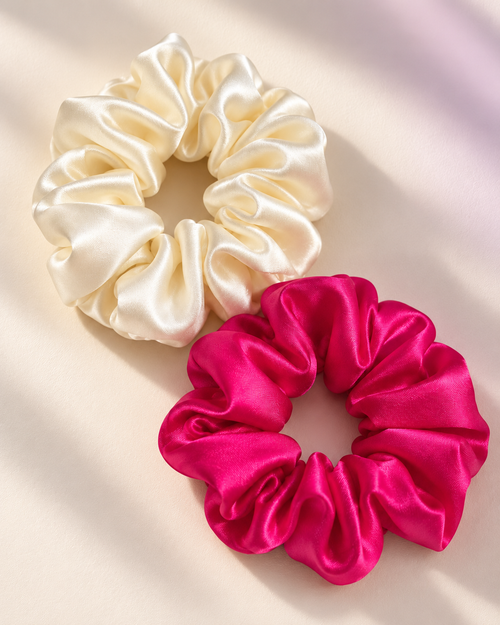 Candy Pop mulberry silk charmeuse scrunchies in Antique White and Hot Pink, laid flat in soft light