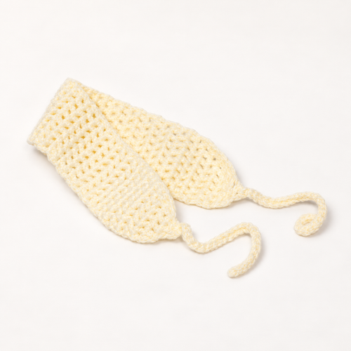 Mellow pale yellow crochet tie headband with two ties on a warm ivory studio background