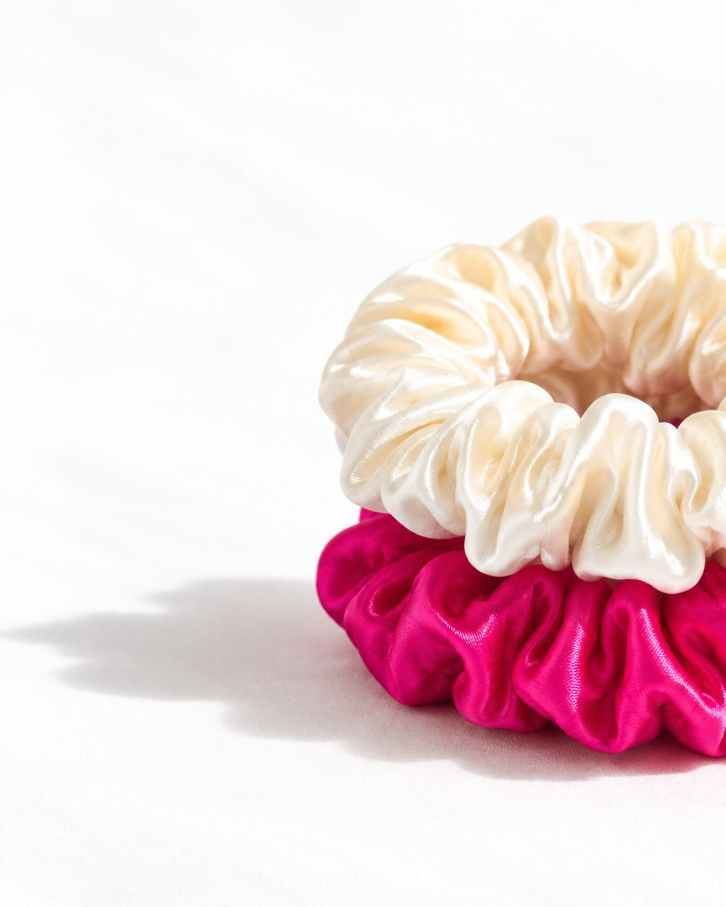 Close-up of the fine hand-gathered folds of a Candy Dot mulberry silk scrunchie