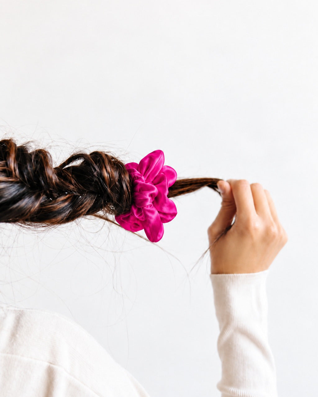 Tying off a braid with a Hot Pink Candy Dot skinny silk scrunchie